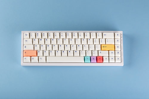 PBT Cherry Notion keycaps installed on a compact keyboard, showing the exact cream colorway, colorful accent keys and Notion icon legends